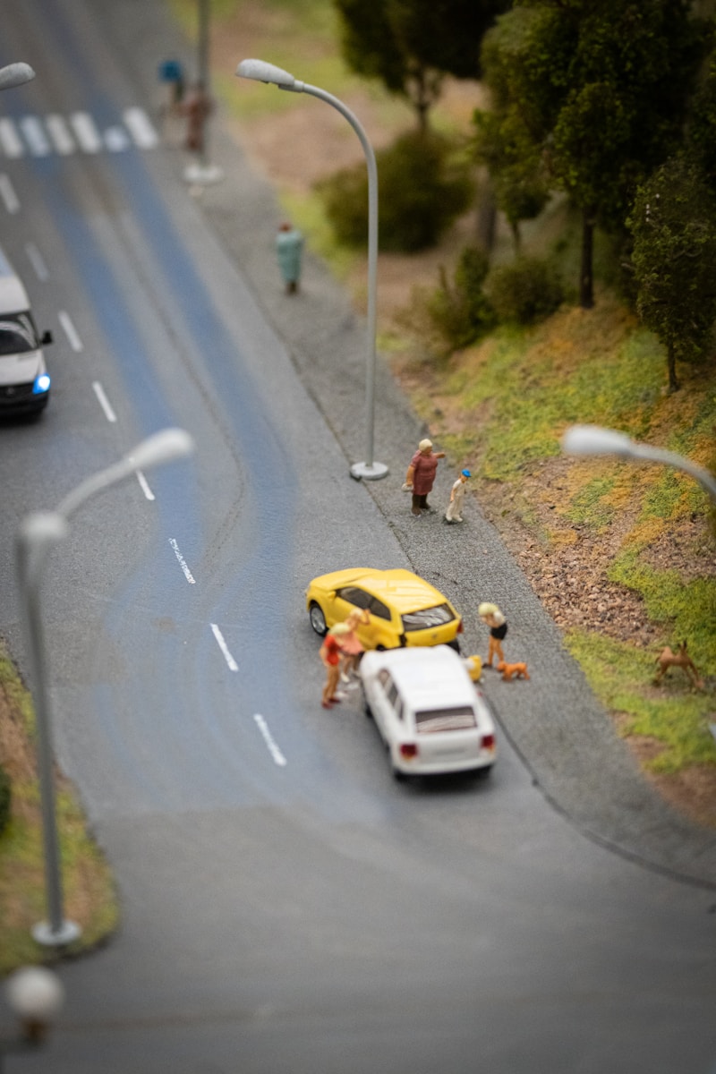 a toy model of a car being towed by a truck after using auto insurance due to collision