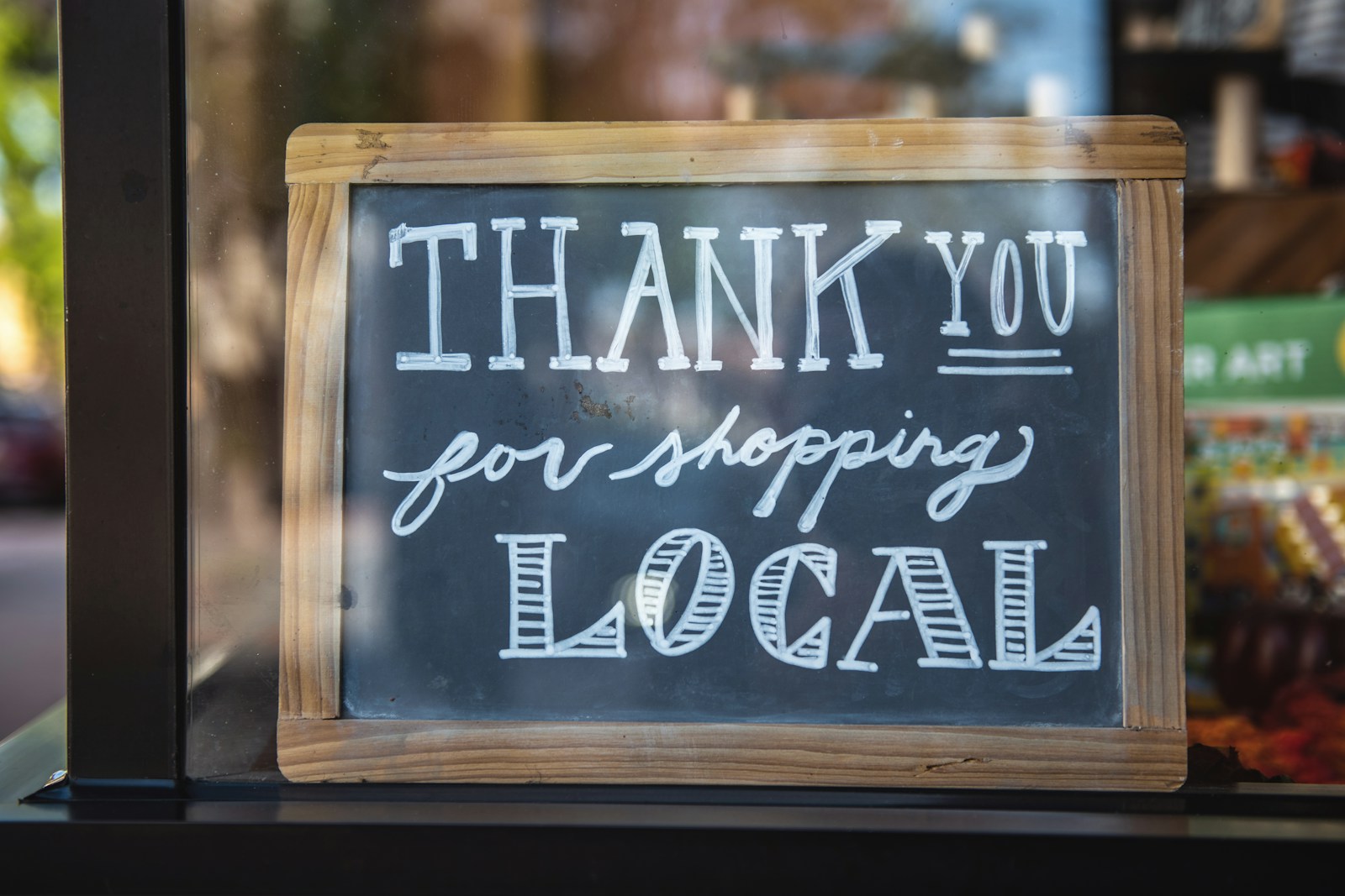 shallow focus photo of thank you for shopping signage from a local shop with small business insurance